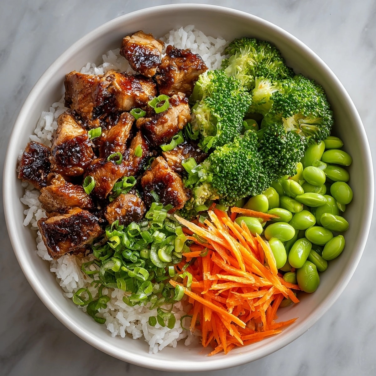 Freshly prepared Teriyaki Chicken Rice Bowls with tender chicken and a glossy homemade teriyaki glaze.
