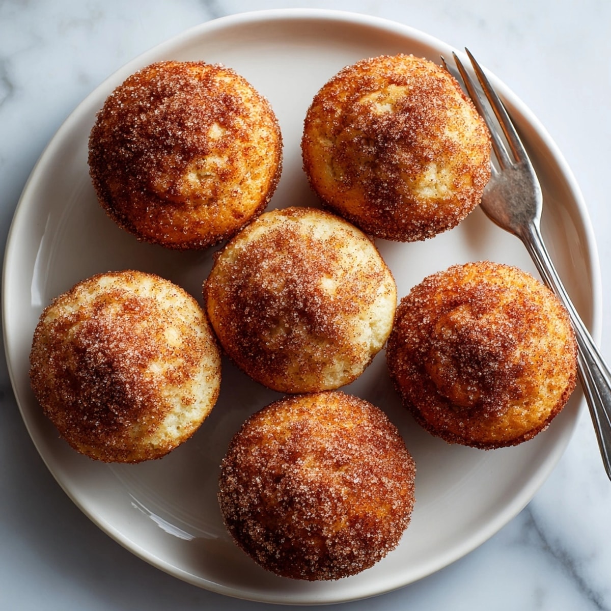 Warm spiced apple cider doughnut muffins served for breakfast, with a rustic, homemade bakery feel