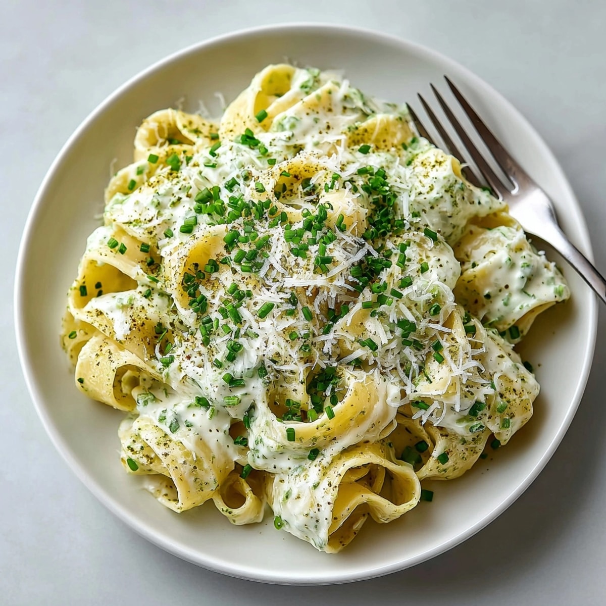 A beautiful forkful of Matcha White Sauce Pasta, rich and flavorful with green tea accents.