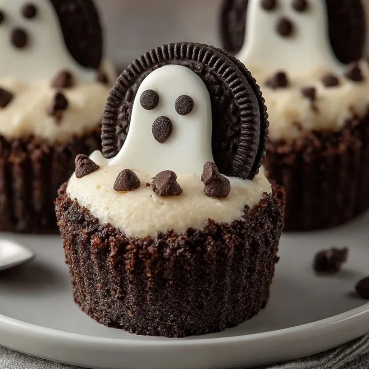 Bite-sized Mini Ghost Cheesecake Cups: Rich creamy cheesecake on a chocolatey cookie crust.