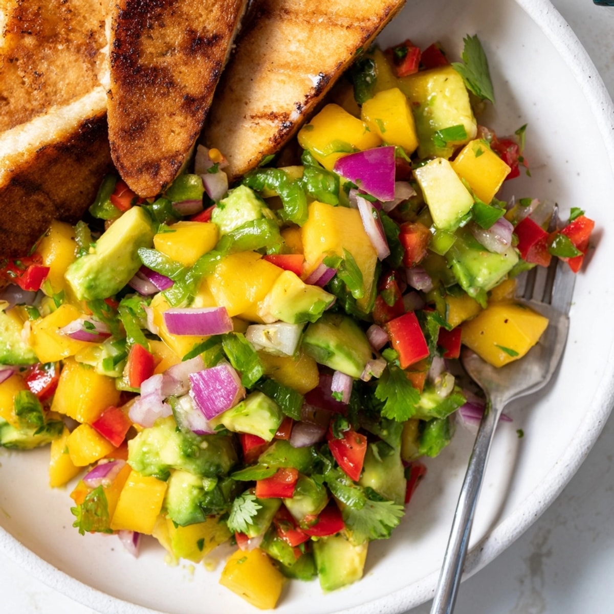 Delicious, vibrant Mango Avocado Salsa with Chicken Sausage, ready to enjoy fresh.