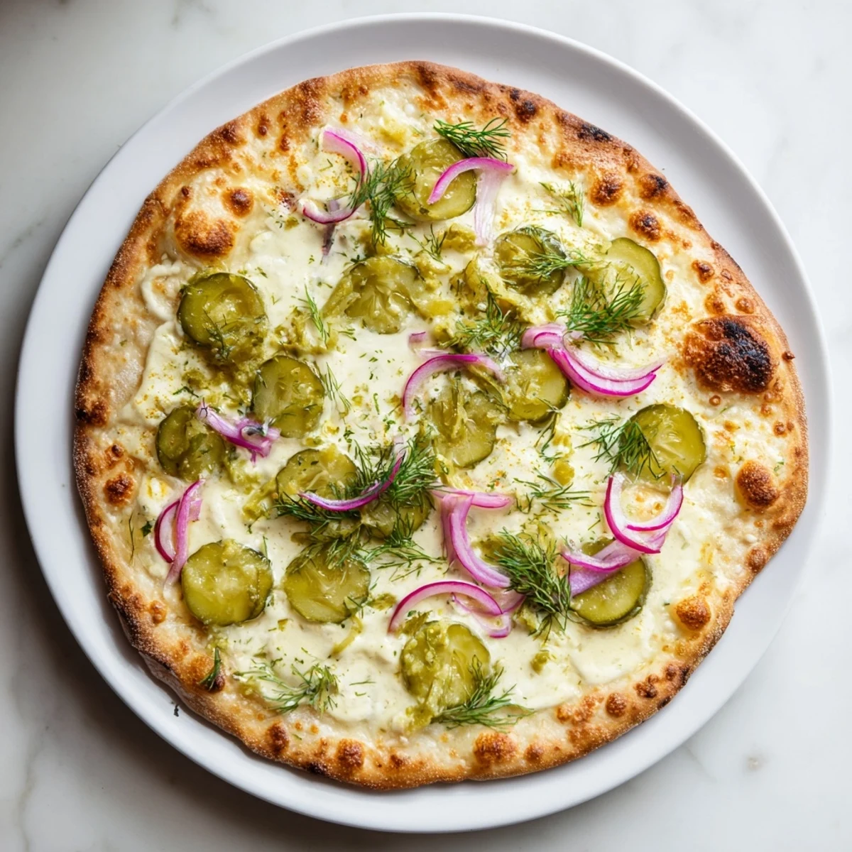 Enjoy a unique Pickle Pizza with melted mozzarella and fresh dill garnish.  