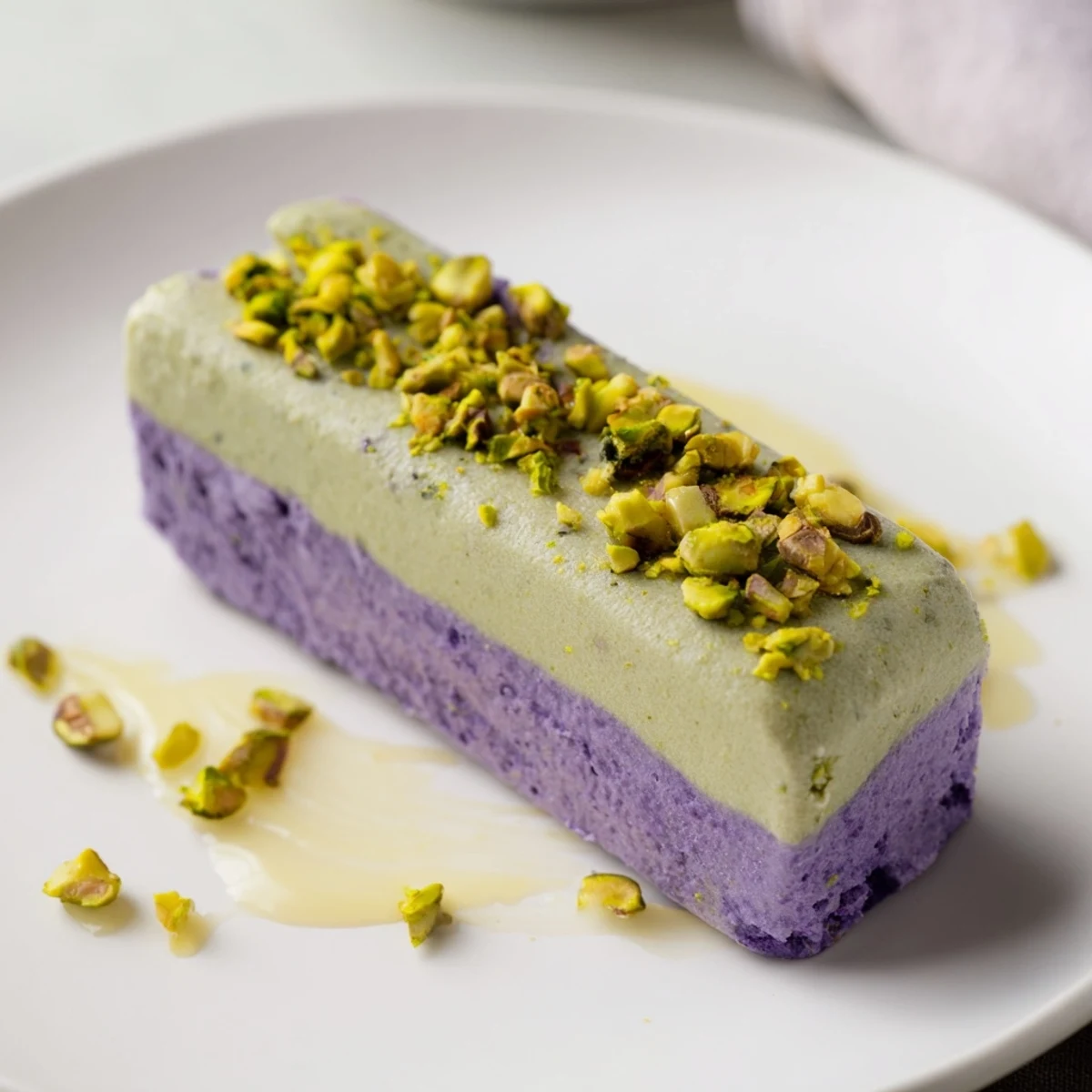 Creamy Ube & Pistachio Ice Cream Bars topped with chopped nuts, perfect for summer enjoyment.  