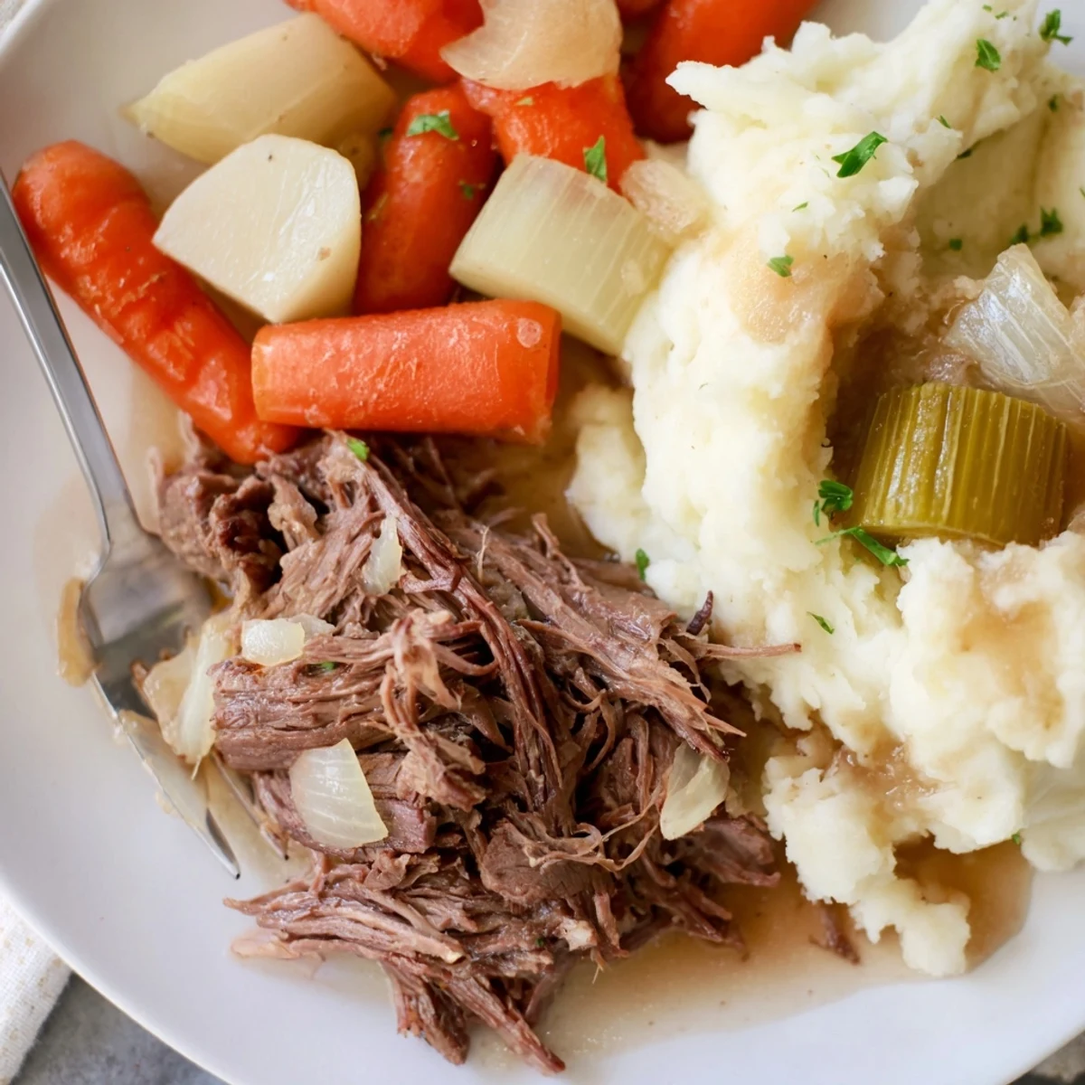 A classic slow cooker pot roast garnished with fresh parsley and vegetables.  