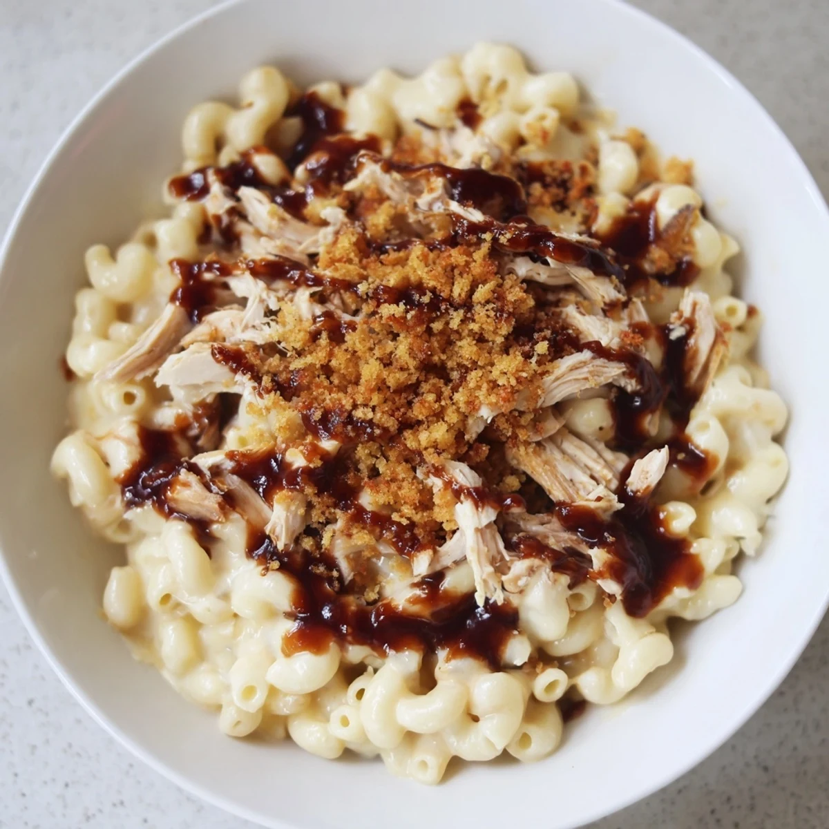 Generous portion of Classic Mac & Cheese with BBQ Chicken, showcasing a family-pleasing combination of textures.