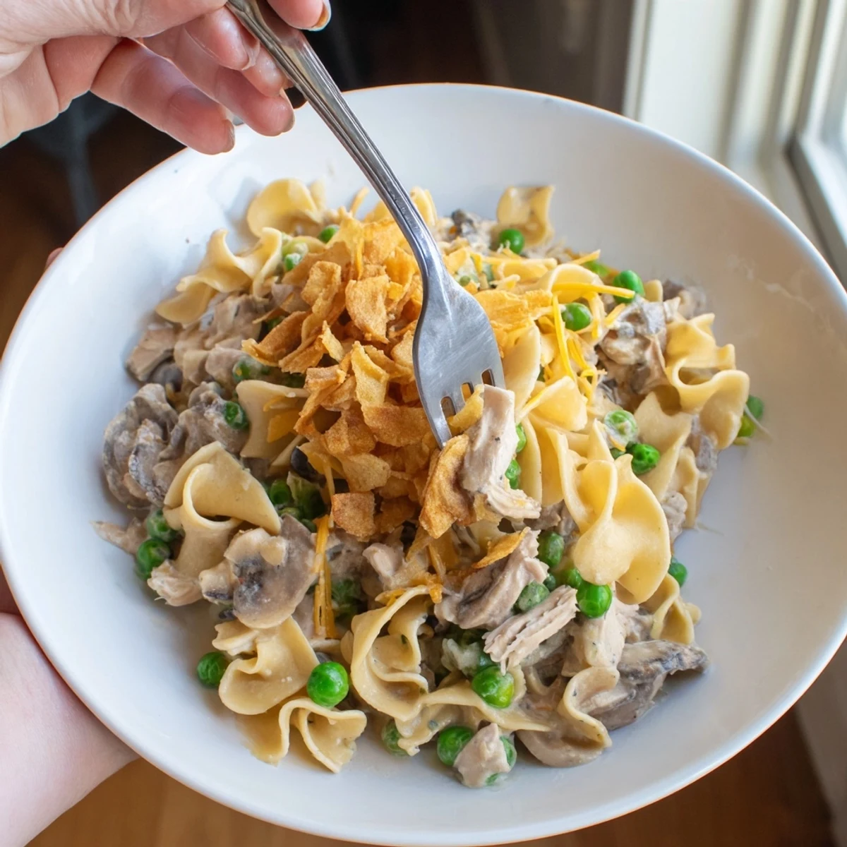 Creamy tuna noodle casserole with golden crispy onions, a comforting baked American classic.