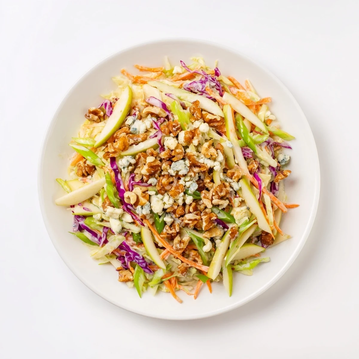 Vibrant Crunchy Apple & Walnut Slaw with Blue Cheese, ready to serve with creamy crumbles and toasted walnuts.