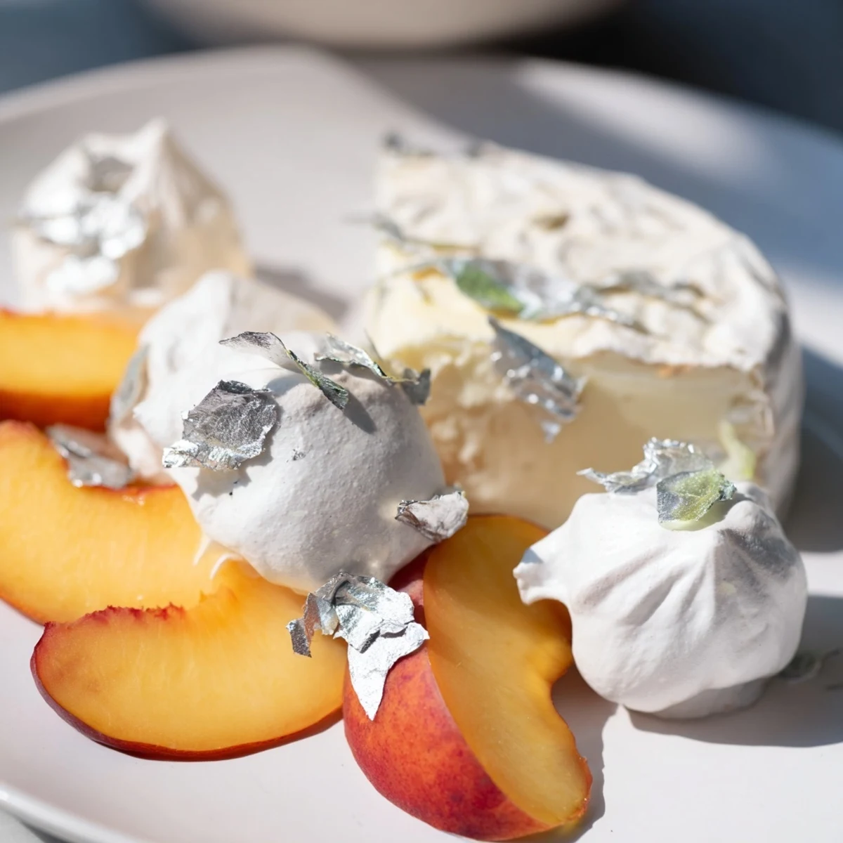 A heavenly view of The Pearly Gates cheese board, featuring creamy brie and delicate silver leaf.