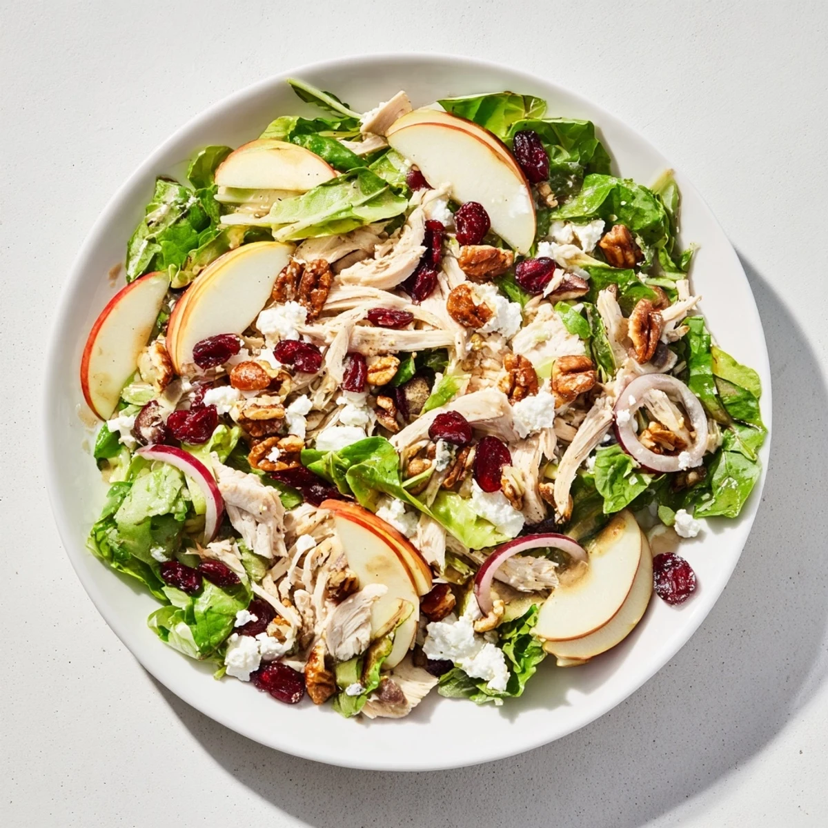 Close-up of the delicious Chicken and Apple Winter Salad, with vibrant greens and sweet apple slices.