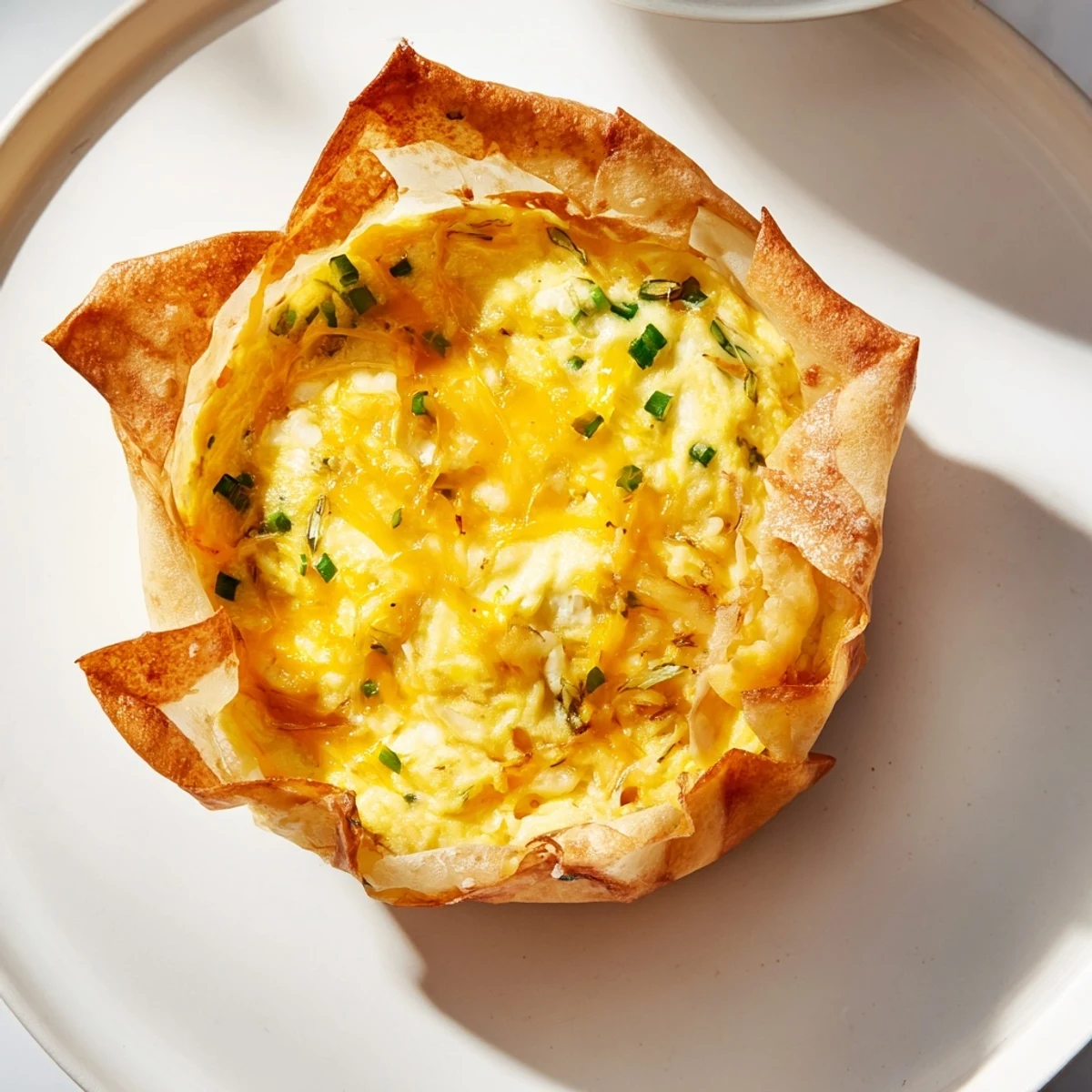 A warm Rice Paper Egg & Cheese Fold, showcasing the fluffy egg and fresh scallions served hot.