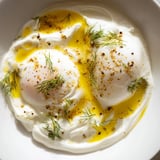 A beautiful close-up of Cilbir: rich yolk, vibrant spices, and herbed yogurt, a Turkish breakfast delight.