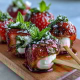Strawberry Caprese skewers with juicy strawberries, fresh mozzarella, and basil leaves, drizzled with sweet balsamic reduction for a bright appetizer.
