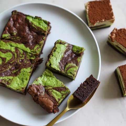 Delicious matcha-miso brownies topped with a glossy chocolate glaze and vibrant matcha.  