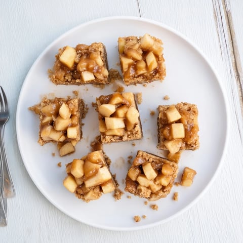 Golden, gooey Caramel Apple Cookie Bars topped with crumbles, offering a sweet fall treat.