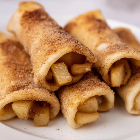 Warm and crispy Apple Pie Roll-Ups, golden brown and sprinkled with cinnamon sugar, ready to eat!