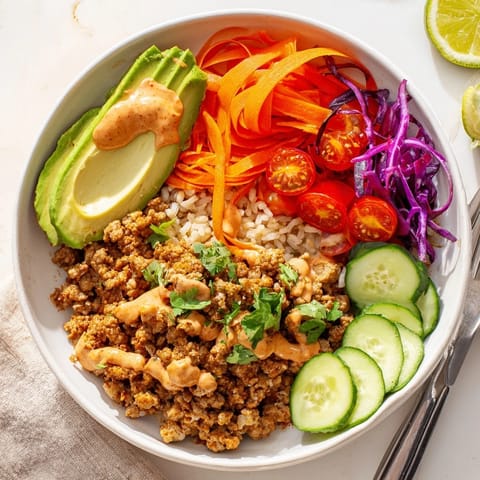 Deliciously seasoned plant-based meat bowl with avocado and colorful toppings.  