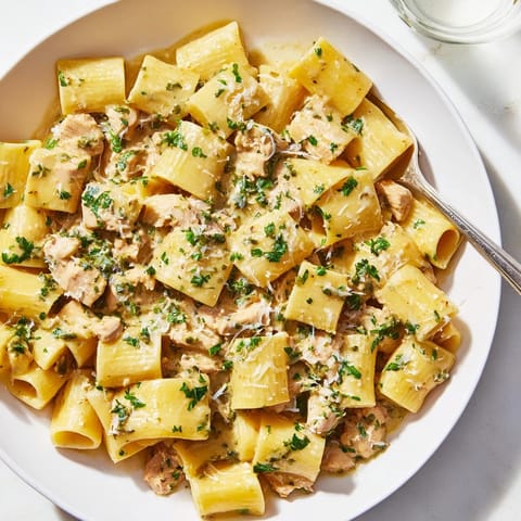Deliciously comforting Creamy Garlic Parmesan Chicken Rigatoni, served with a side of crusty bread.  
