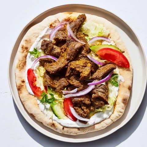 A close-up of a flavorful pile of Beef Shawarma Wraps, ready to eat, with all the fillings visible.
