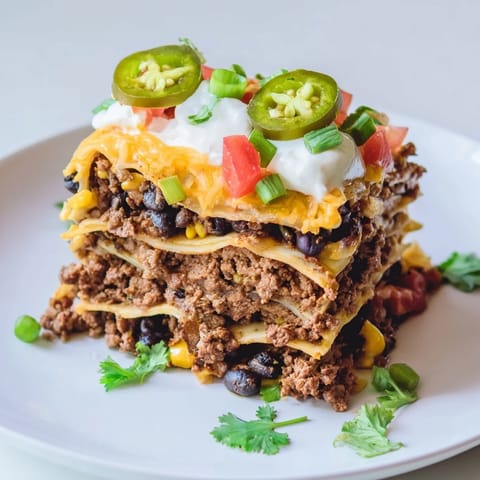 Melting cheese covers this hearty Taco Lasagna, a delicious fusion of flavors and comforting textures.