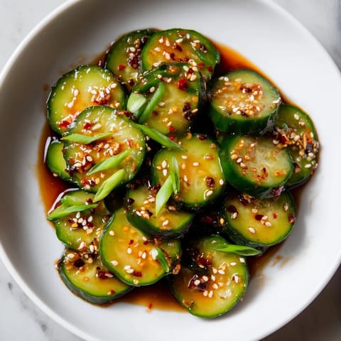 Close-up of freshly made Shake Shake Garlic Cucumbers – crunchy cucumbers doused in a soy-sesame dressing.