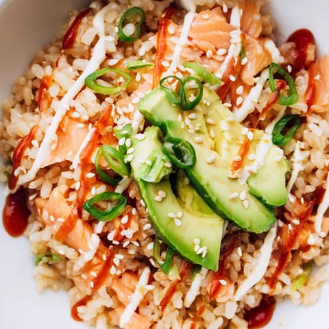 This Emily Mariko Salmon Rice Bowl features creamy avocado and perfectly seasoned rice, ready to eat.