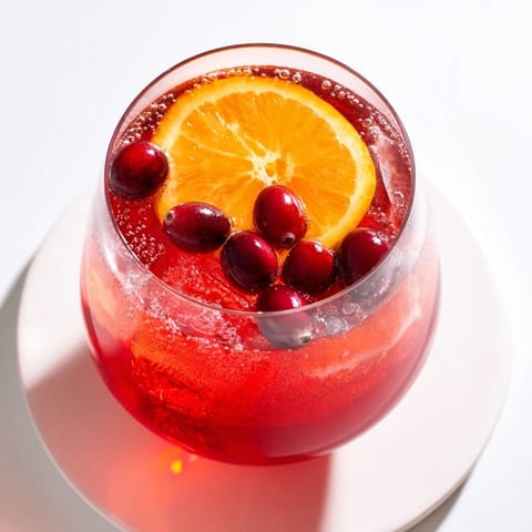 Bright red 3-Ingredient Holiday Punch, bubbly and cold, ready for dipping cups at a party.