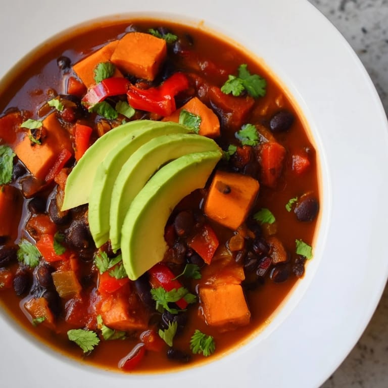 Rich, flavorful Sweet Potato & Black Bean Chili, perfect for a cozy weeknight dinner with friends.