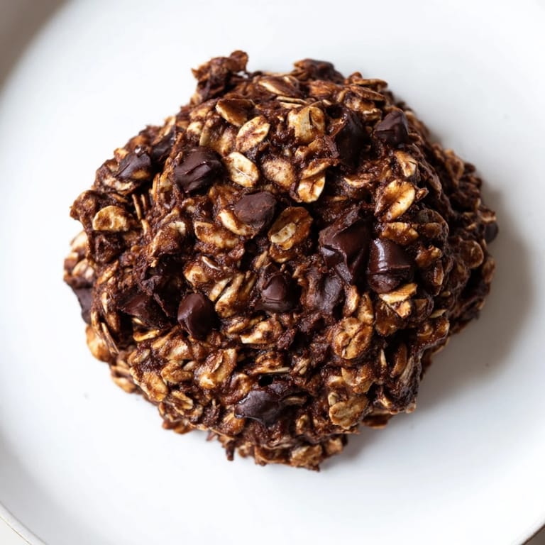 A stack of delicious chocolate oatmeal breakfast cookies, fresh from the oven, offering a delightful aroma.