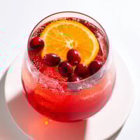 Bright red 3-Ingredient Holiday Punch, bubbly and cold, ready for dipping cups at a party.